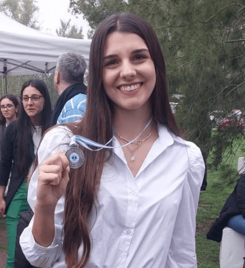 Valentina mostrando una medalla en un evento